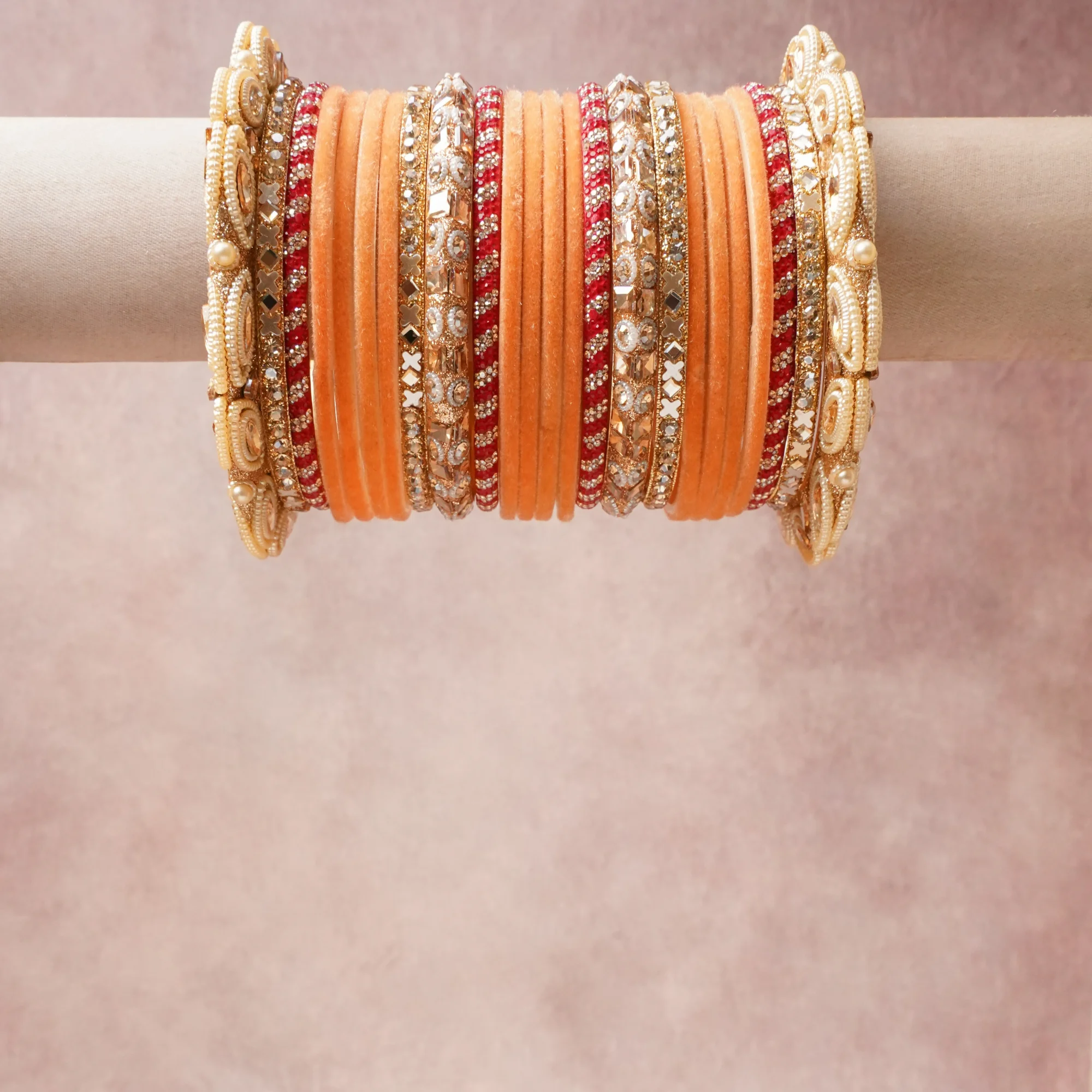 A grounding Muted Peach forms the heart of the set, while touches of Gold, Crimson Red, Clear add charm.

A thoughtful composition of Velvet, Gold-Toned Metal, Crystal, Faux Pearl, Silk Thread, designed to feel complete without being heavy.
Each element layers seamlessly, creating a look that is refined, wearable and quietly striking.